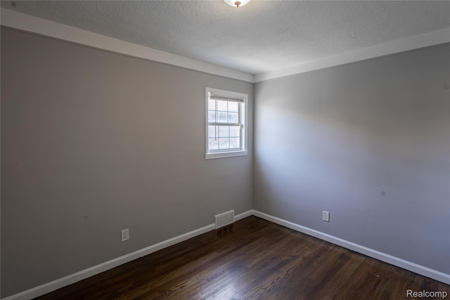 22613 Raven Ave, Eastpointe, MI 48021 - unfurnished room featuring dark wood finished floors and a textured ceiling