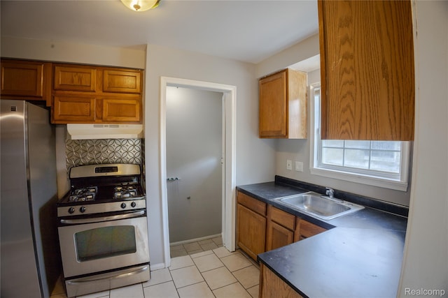 22613 Raven Ave, Eastpointe, MI 48021 - kitchen featuring stainless steel appliances, under cabinet range hood, dark countertops, and brown cabinetry