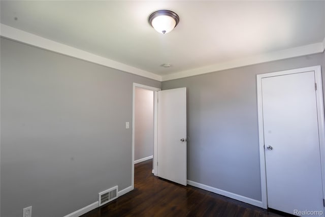 22613 Raven Ave, Eastpointe, MI 48021 - unfurnished bedroom with baseboards and dark wood-type flooring