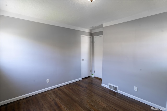 22613 Raven Ave, Eastpointe, MI 48021 - spare room featuring baseboards and dark wood-type flooring