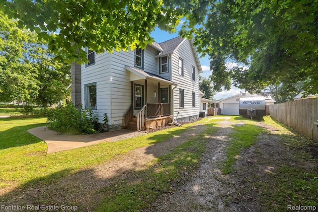 1 Grand Blvd, Battle Creek, MI 49015 - view of front of property featuring dirt driveway, a garage, and an outbuilding