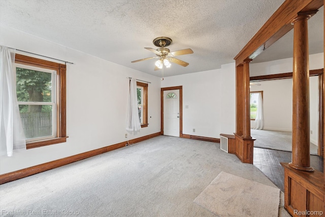 1 Grand Blvd, Battle Creek, MI 49015 - unfurnished room featuring ornate columns, healthy amount of natural light, carpet flooring, a ceiling fan, and a textured ceiling