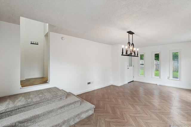 1 Grand Blvd, Battle Creek, MI 49015 - unfurnished room with a textured ceiling and a chandelier