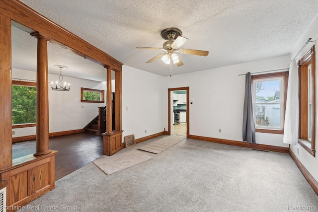 1 Grand Blvd, Battle Creek, MI 49015 - spare room with light carpet, ornate columns, a textured ceiling, a chandelier, and a ceiling fan