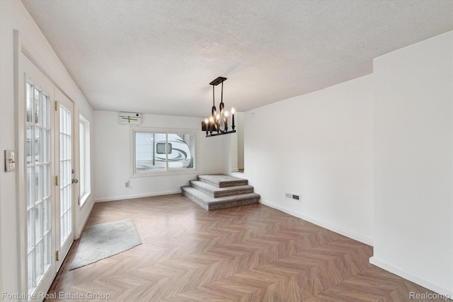 1 Grand Blvd, Battle Creek, MI 49015 - unfurnished dining area with a chandelier, a textured ceiling, and stairway