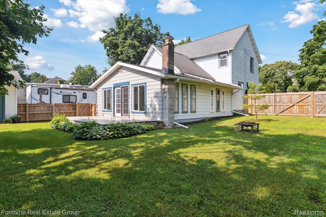 1 Grand Blvd, Battle Creek, MI 49015 - back of house featuring a chimney, a fenced backyard, a fire pit, and a shingled roof
