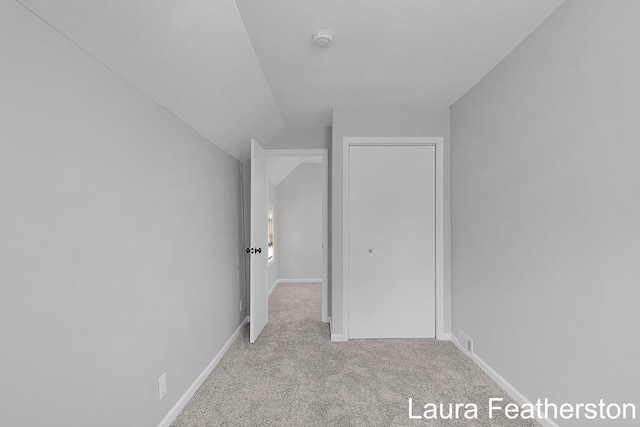 1119 White Ave NW, Grand Rapids, MI 49504 - unfurnished bedroom featuring carpet flooring and vaulted ceiling