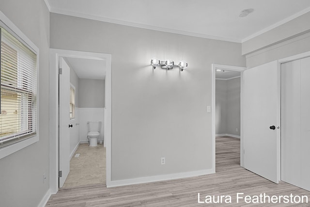 1119 White Ave NW, Grand Rapids, MI 49504 - unfurnished bedroom featuring crown molding, light wood finished floors, and a closet