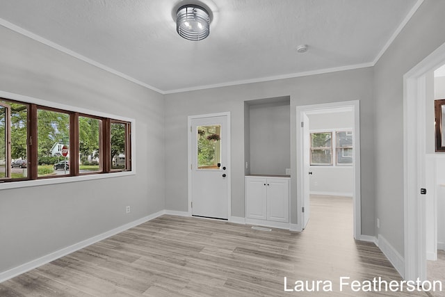 1119 White Ave NW, Grand Rapids, MI 49504 - spare room featuring light wood-type flooring, crown molding, and a smoke detector