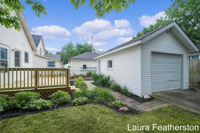 1119 White Ave NW, Grand Rapids, MI 49504 - view of yard with a deck, an outbuilding, driveway, and a garage