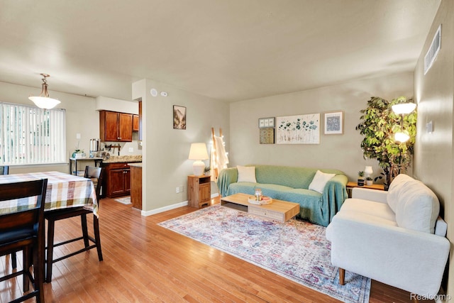 2220 Orchard Crest St, Shelby Twp, MI 48317 - living room featuring light wood-style floors and baseboards