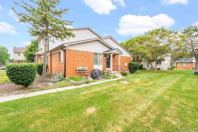 2220 Orchard Crest St, Shelby Twp, MI 48317 - view of front of home featuring brick siding and a front yard
