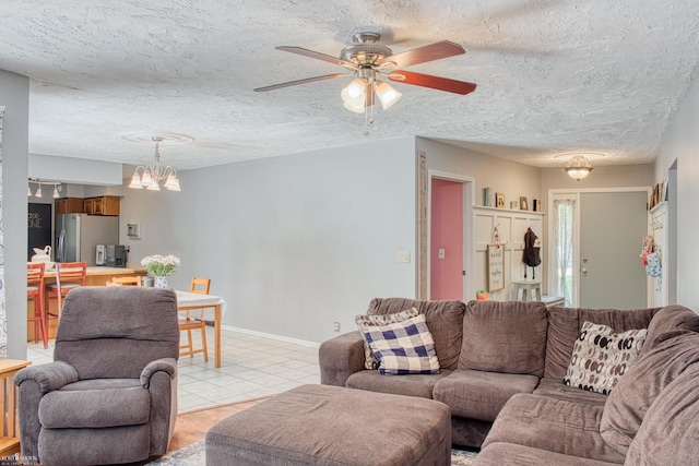 279 Ardelean Dr, Owosso, MI 48867 - living room with ceiling fan, a textured ceiling, and a chandelier