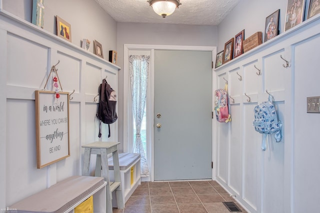 279 Ardelean Dr, Owosso, MI 48867 - mudroom with a textured ceiling, tile patterned floors, and healthy amount of natural light