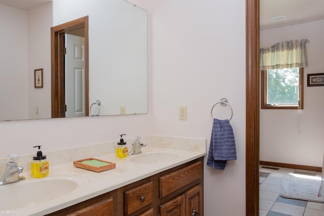 279 Ardelean Dr, Owosso, MI 48867 - bathroom featuring double vanity and tile patterned floors