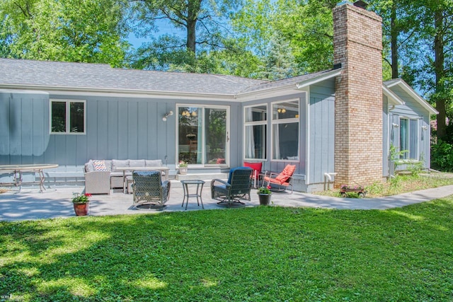 279 Ardelean Dr, Owosso, MI 48867 - back of house featuring outdoor lounge area, a chimney, a patio area, and a lawn