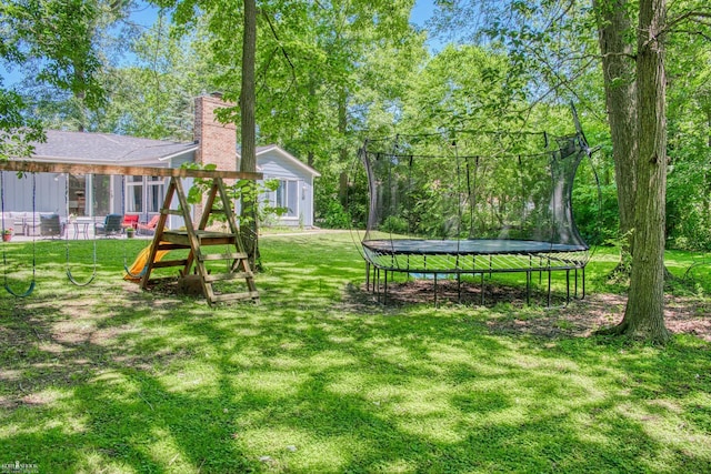 279 Ardelean Dr, Owosso, MI 48867 - view of grassy yard with a trampoline