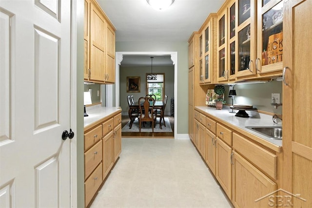 2816 Chippewa Ln, Midland, MI 48640 - kitchen featuring light countertops, glass insert cabinets, pendant lighting, and light floors