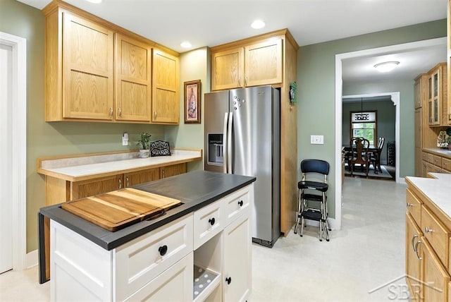 2816 Chippewa Ln, Midland, MI 48640 - kitchen with stainless steel fridge, dark countertops, recessed lighting, glass insert cabinets, and light brown cabinets