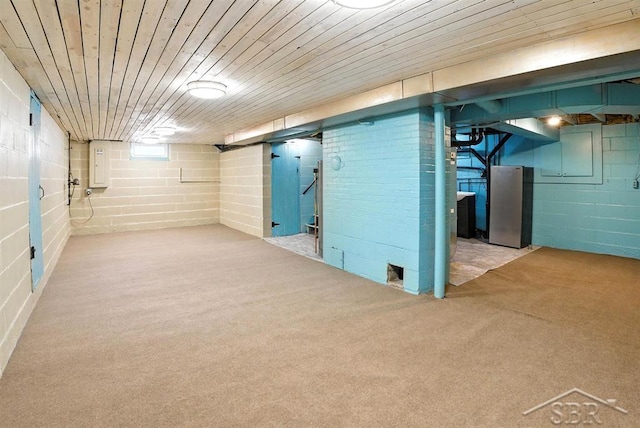 2816 Chippewa Ln, Midland, MI 48640 - finished basement featuring freestanding refrigerator, carpet flooring, electric panel, and wooden ceiling