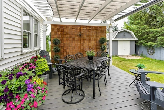 2816 Chippewa Ln, Midland, MI 48640 - deck with outdoor dining space, a storage shed, and a pergola