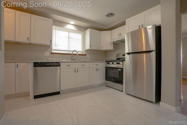 23320 Beechwood Ave, Eastpointe, MI 48021 - kitchen featuring appliances with stainless steel finishes, light marble finish flooring, white cabinetry, light countertops, and recessed lighting