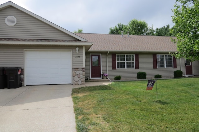 3577 Greenly Ct, Holland, MI 49424 - ranch-style house featuring concrete driveway, a garage, a front lawn, and a shingled roof