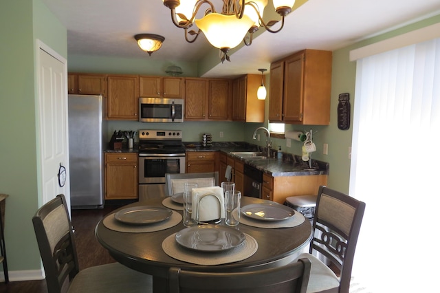 3577 Greenly Ct, Holland, MI 49424 - kitchen with stainless steel appliances, dark countertops, and brown cabinets