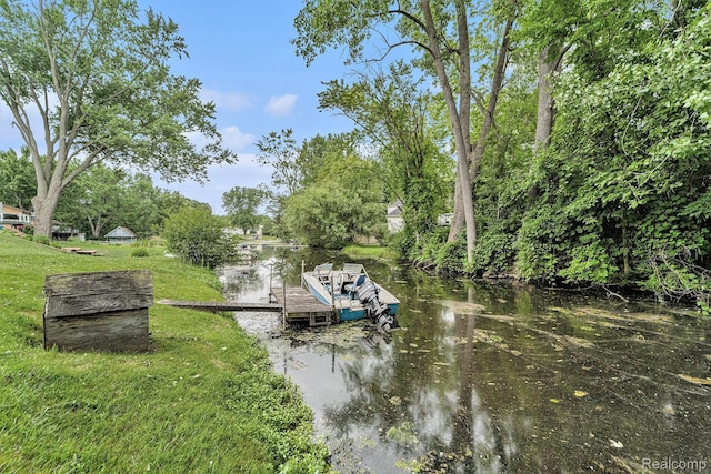 5690 Corunna Ave, Clarkston, MI 48346 - dock with a water view, a lawn, and view of scattered trees
