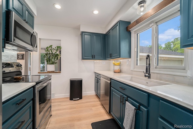 5690 Corunna Ave, Clarkston, MI 48346 - kitchen featuring stainless steel appliances, decorative backsplash, light countertops, light wood finished floors, and recessed lighting