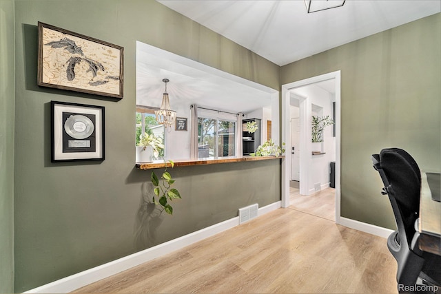 5690 Corunna Ave, Clarkston, MI 48346 - home office with wood finished floors and a chandelier