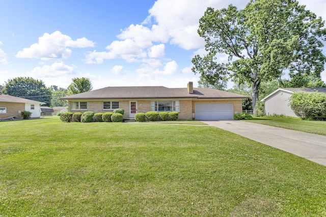 1515 Kensington Dr, Jackson, MI 49203 - ranch-style home featuring concrete driveway, a garage, a chimney, and a front lawn