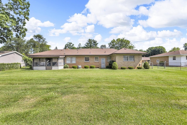 1515 Kensington Dr, Jackson, MI 49203 - rear view of property featuring a sunroom and brick siding