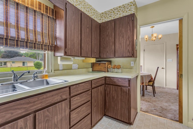 1515 Kensington Dr, Jackson, MI 49203 - kitchen featuring light countertops, a chandelier, and light flooring