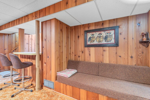 1515 Kensington Dr, Jackson, MI 49203 - living room featuring wood walls and a bar