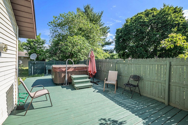 863 E Wilcox Ave, White Cloud, MI 49349 - deck with a hot tub and a fenced backyard