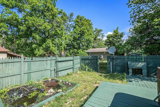 863 E Wilcox Ave, White Cloud, MI 49349 - fenced backyard with a deck