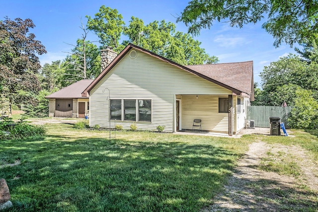 863 E Wilcox Ave, White Cloud, MI 49349 - rear view of house with a chimney