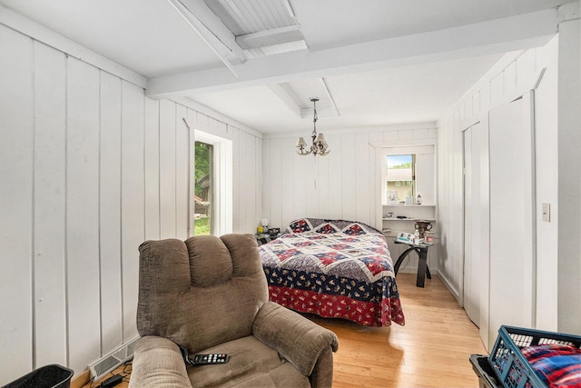 863 E Wilcox Ave, White Cloud, MI 49349 - bedroom featuring beamed ceiling, multiple windows, and light wood-style floors