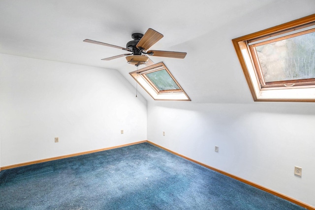 863 E Wilcox Ave, White Cloud, MI 49349 - additional living space with a skylight, ceiling fan, vaulted ceiling, and carpet flooring