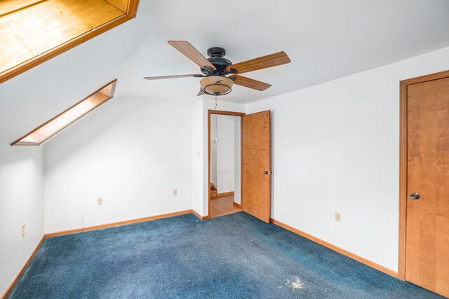 863 E Wilcox Ave, White Cloud, MI 49349 - unfurnished bedroom with a skylight, carpet flooring, and a ceiling fan