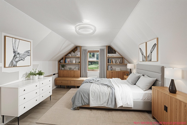 863 E Wilcox Ave, White Cloud, MI 49349 - bedroom with wood finished floors and lofted ceiling