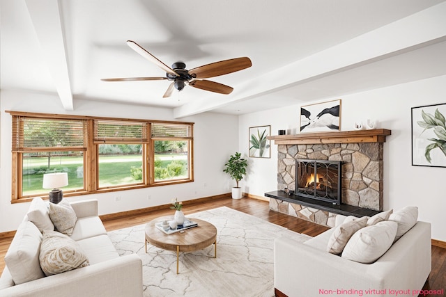 863 E Wilcox Ave, White Cloud, MI 49349 - living area featuring plenty of natural light, beam ceiling, a fireplace, and wood finished floors