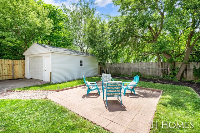 1545 Fuller Ave NE, Grand Rapids, MI 49505 - fenced backyard featuring an outdoor structure, a detached garage, and a patio area