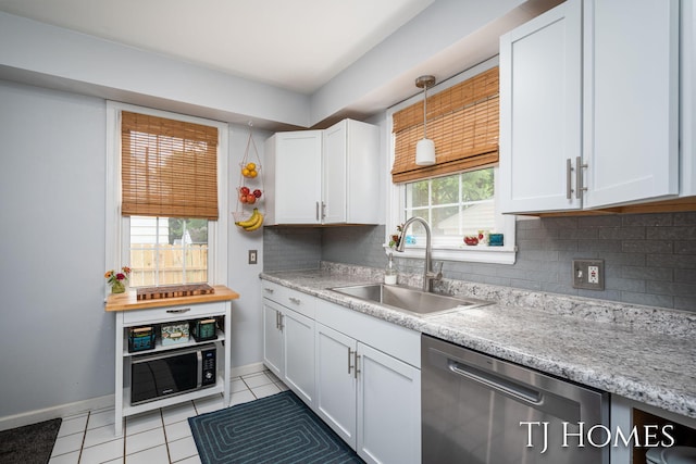 1545 Fuller Ave NE, Grand Rapids, MI 49505 - kitchen with stainless steel dishwasher, light tile patterned flooring, healthy amount of natural light, and backsplash