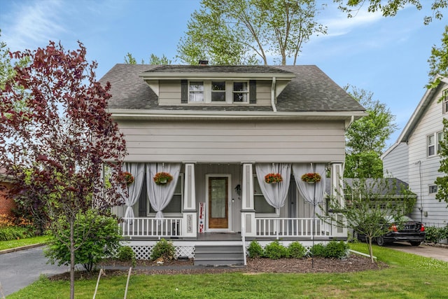 313 Moross Rd, Grosse Pointe Farms, MI 48236 - view of front facade with a porch, roof with shingles, and a front yard