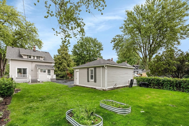 313 Moross Rd, Grosse Pointe Farms, MI 48236 - view of green lawn featuring an outdoor structure and a garden