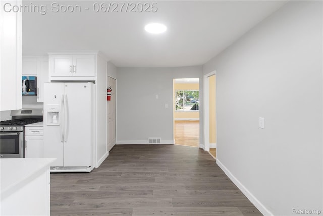 29405 Van Laan Dr, Warren, MI 48092 - kitchen featuring appliances with stainless steel finishes, white cabinetry, wood finished floors, and light countertops