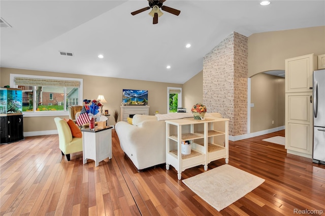 8320 Lagoon St, Commerce Twp, MI 48382 - living room featuring arched walkways, a ceiling fan, light wood finished floors, recessed lighting, and a fireplace