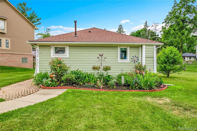 8320 Lagoon St, Commerce Twp, MI 48382 - view of home's exterior featuring a lawn and a shingled roof